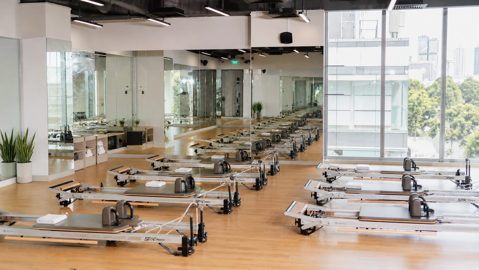 Absolute Pilates Singapore reformer studio class with members on equipment