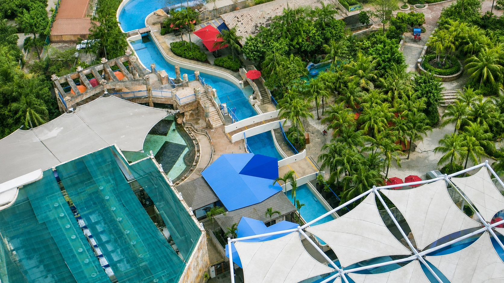 Kids on water slides and families snorkelling at Adventure Cove Waterpark Sentosa Singapore