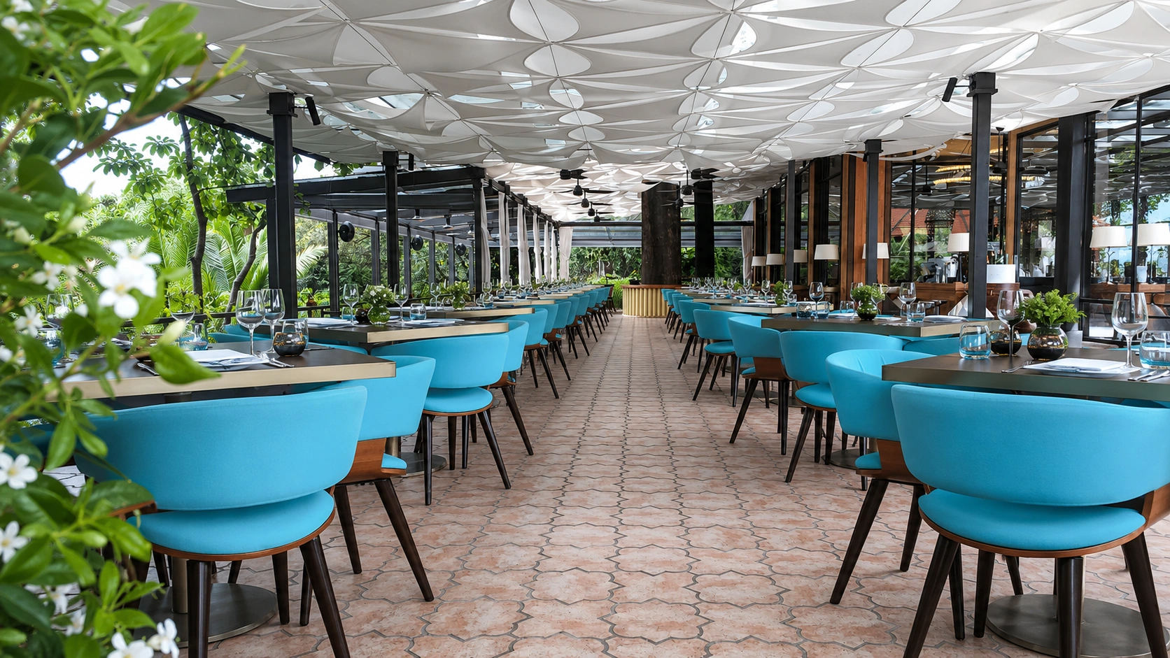 Families relaxing at the large pool surrounded by tropical gardens at Sofitel Singapore Sentosa Resort