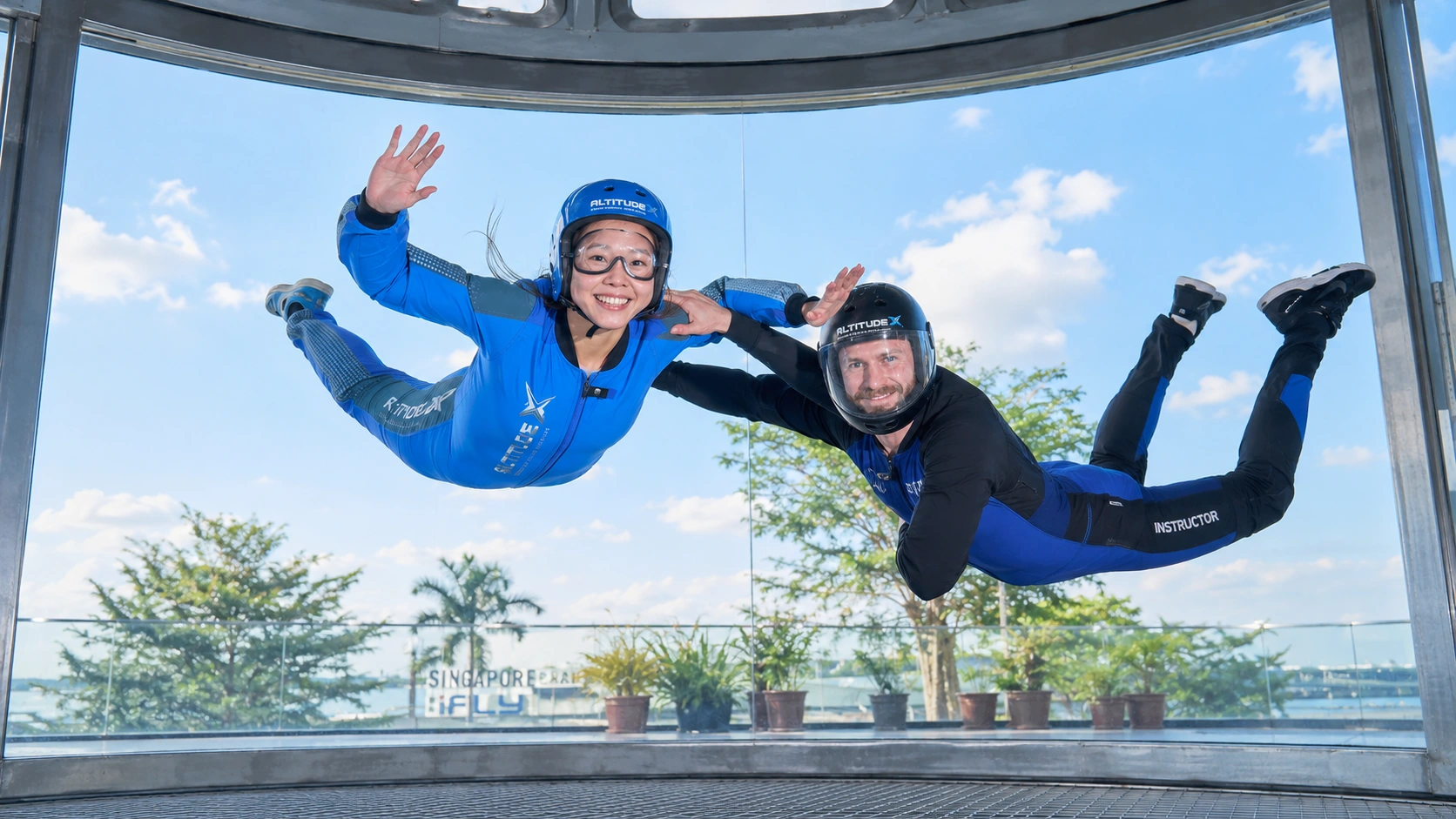 Child indoor skydiving in the iFly Singapore vertical wind tunnel on Sentosa